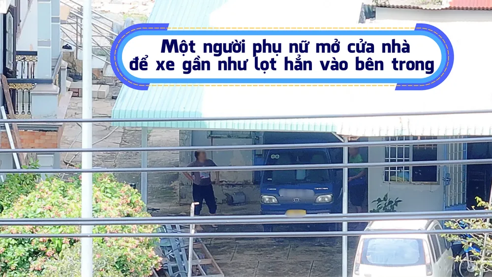 12. Một người phụ nữ mở cửa nhà để xe gần như lọt hẳn vào bên trong .png