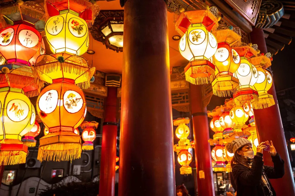 Người dân chụp ảnh bên cạnh những chiếc đèn lồng ở khu phố Tàu thuộc TP Yokohama, Nhật. Ảnh: AFP Người dân chụp ảnh bên cạnh những chiếc đèn lồng ở khu phố Tàu thuộc TP Yokohama, Nhật. Ảnh: AFP