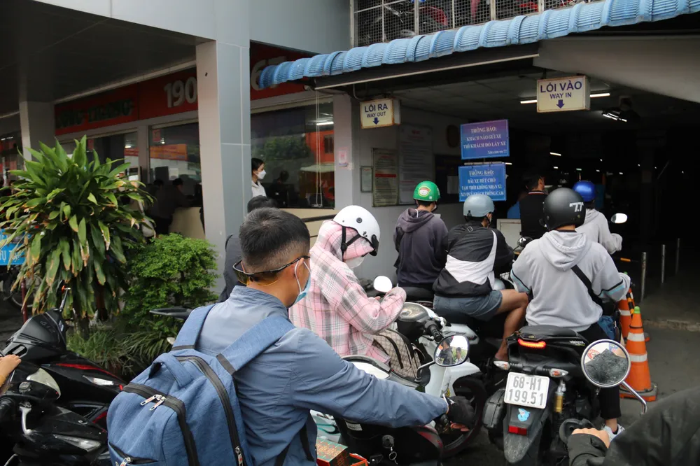 Bãi giữ xe hai bánh quá tải, hành khách xếp hàng đợi đến lượt. cua-ngo-phia-tay-146.jpg