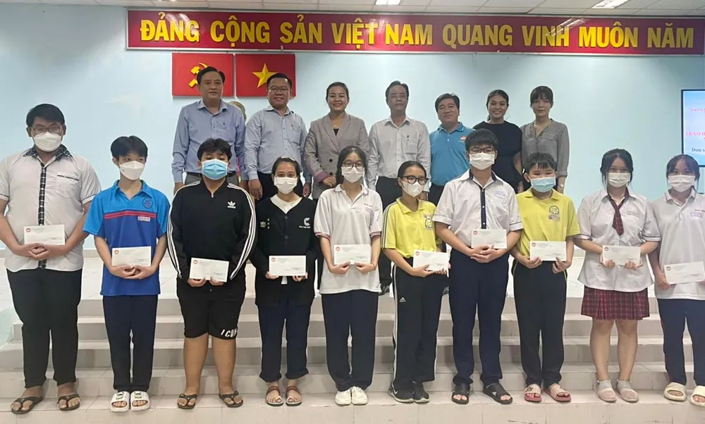 Đại diện Ủy ban MTTQ các cấp và nhà tài trợ chụp hình lưu niệm cùng các em HS-SV được nhận học bổng.