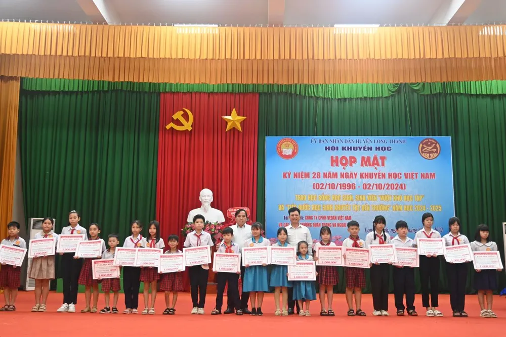 Ông Phạm Trung Thuyên - Chủ tịch Công Đoàn Vedan Việt Nam (phải) trao học bổng cho các em học sinh tại huyện Long Thành. vedan-viet-nam-trao-hon-400-suat-hoc-bong-thap-sang-giac-mo-den-truong-2.JPG