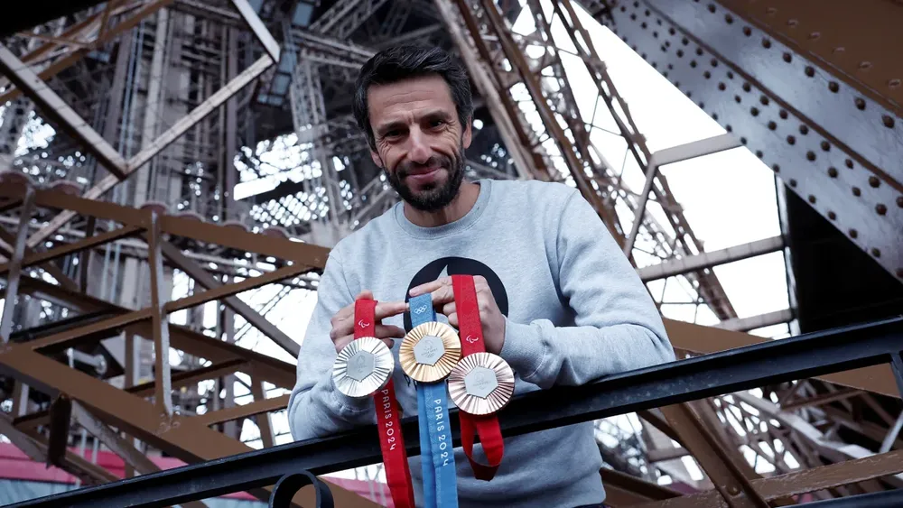 Chủ tịch Ủy ban tổ chức Thế vận hội Olympic Paris 2024, Tony Estanguet tạo dáng với huy chương Olympic và Paralympic trên Tháp Eiffel. Ảnh: REUTERS huy chương Olympic Paris