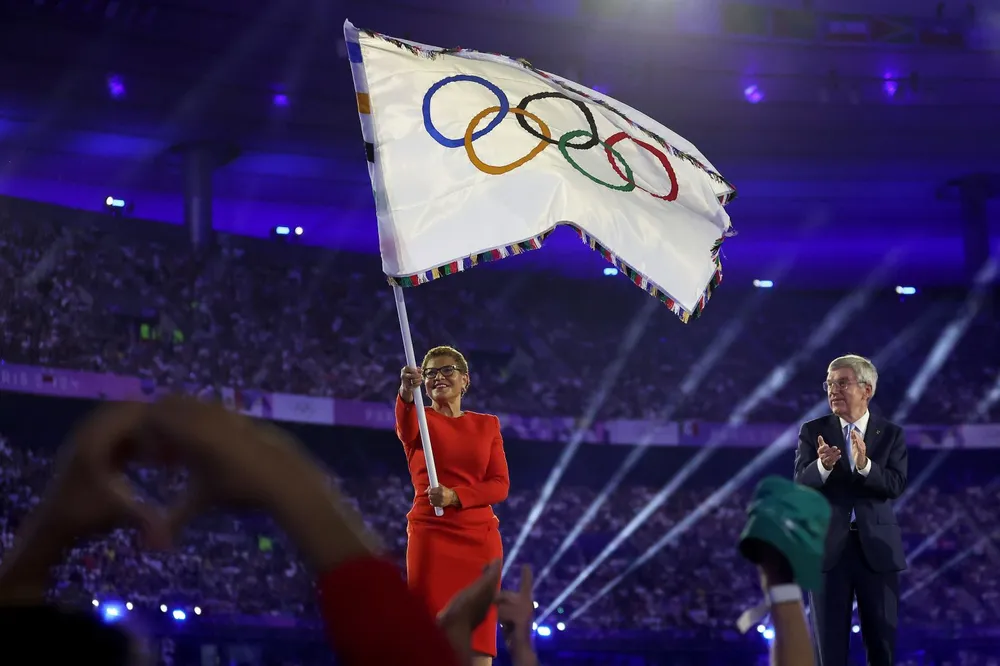 Thị trưởng TP Los Angeles - Karen Bass vẫy cờ Olympic bên cạnh chủ tịch Ủy ban Olympic quốc tế - Thomas Bach. Olympic Paris 2024 bế mạc
