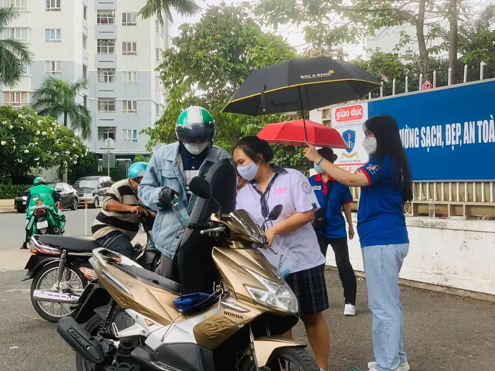 Thí sinh đến trường trong cơn mưa trước giờ thi. Ảnh: THẢO PHƯƠNG Thí sinh đến trường trong cơn mưa trước giờ thi. Ảnh: THẢO PHƯƠNG