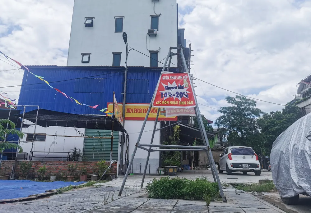 Nhiều cây xanh đã mất gốc, những khung bảo vệ cây được &quot;tận dụng&quot; treo baner quảng cáo. Ảnh PHI HÙNG