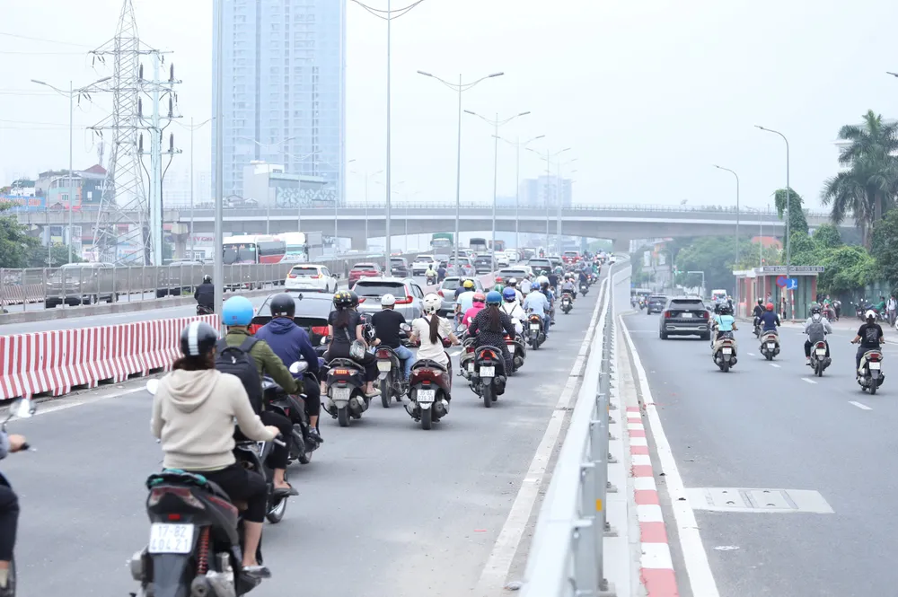 Trong ảnh là ô tô và xe máy lưu thông ở đường vành đai 3 dưới đất khi đến nút giao này thì đi lên phần mở rộng của cầu vượt Mai Dịch. Làn bên trong của cầu vượt cũ chỉ dành cho ô tô đi lên đường vành đai 3 trên cao. cau-mai-dich (5).jpg