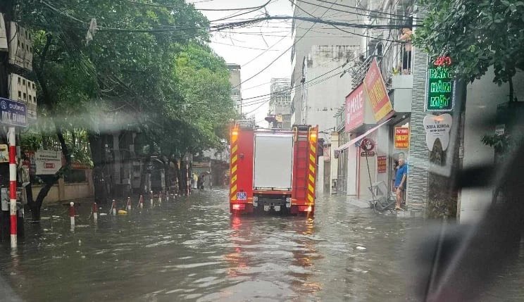 Xe chữa cháy lội nước vào phố Đình Thôn sau khi nhận tin đám cháy chung cư mini sáng nay. Ảnh: CTV z5509183090812_0933712f9535b8b6ef2681b092679729 (1).jpg