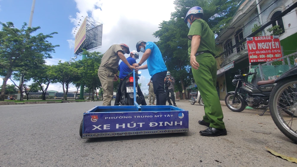 Đội hút đinh của phường Trung Mỹ Tây sở hữu hai xe thực hiện hút đinh hàng ngày trong thời gian qua. Ảnh: NT Công an, Đoàn thanh niên cùng kéo xe hút đinh ở cầu vượt An Sương