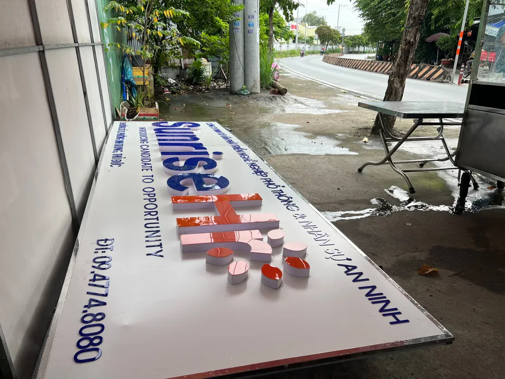 Biển hiệu công ty được tháo dỡ và vứt sang vỉa hè bên cạnh công ty. Ảnh: NGUYỄN YÊN lua-tuyen-dung-2.jpg