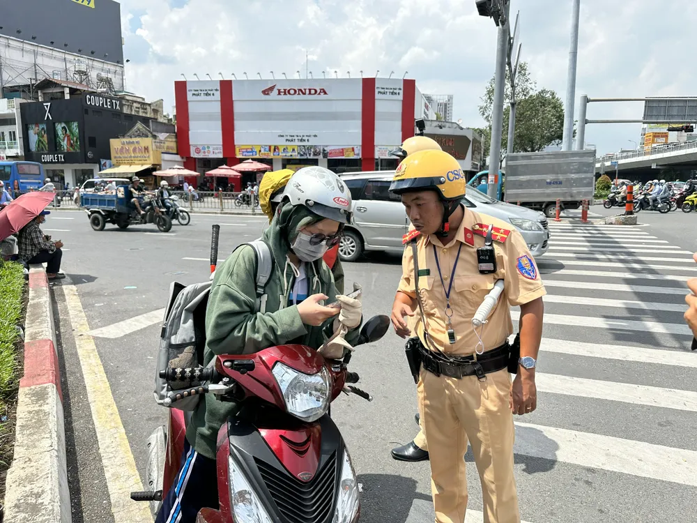 CSGT lập chốt kiểm tra tại khu vực ngã tư Hàng Xanh. Ảnh: NGUYỄN YÊN Học sinh nại đủ lý do khi lái xe máy dù chưa đủ tuổi