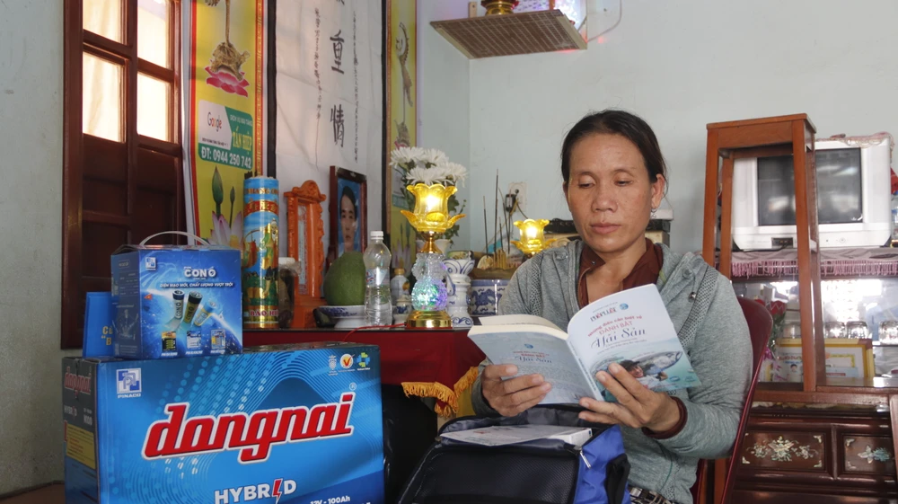 Chị Thu bên phần quà mà chương trình trao tặng cho gia đình vươn khơi, bám biển. Ảnh: NGUYỄN YÊN. anh-bai-ngu-dan (11).JPG