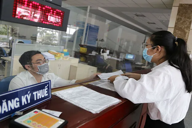 Người dân và doanh nghiệp làm thủ tục thuế. Ảnh: PLO