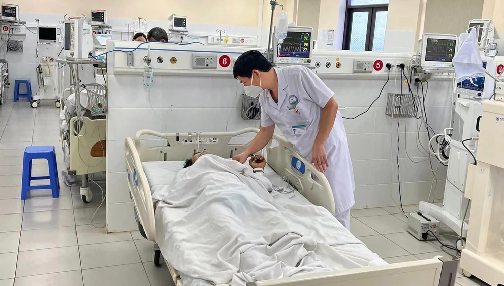 Bác sĩ Hoàng Công Tình thăm hỏi sức khoẻ bệnh nhân uốn ván tại khoa Hồi sức tích cực và Chống độc. Ảnh: BS