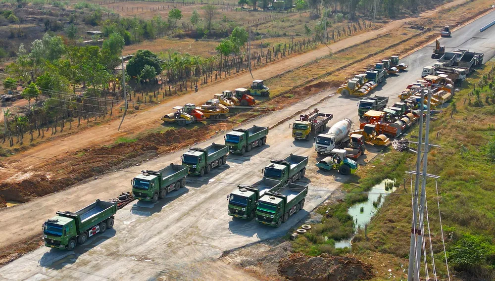 Cơ giới đậu kín đường không hoạt động vì thiếu đất đắp. Ảnh PN.