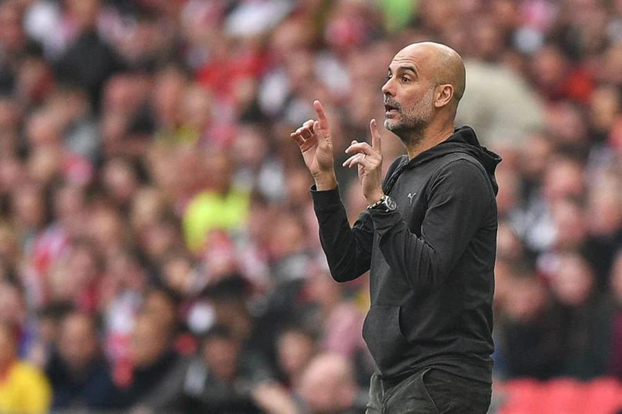 Pep Guardiola chắc chắn muốn Man City tái hiện cú ăn ba lịch sử của kình địch Man Utd. ẢNH: GETTY