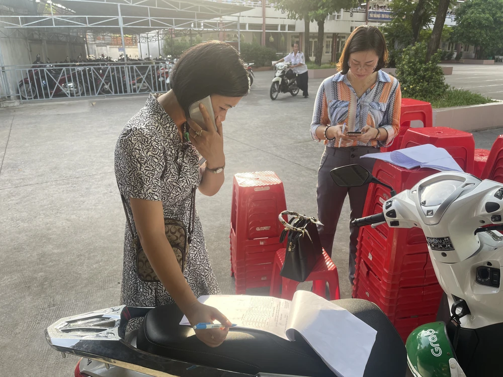Thí sinh nào chưa tới sẽ được các cô gọi điện để nhắc nhở phụ huynh đưa đi thi đúng giờ. Ảnh: TRẦN MINH thi vào lớp 10