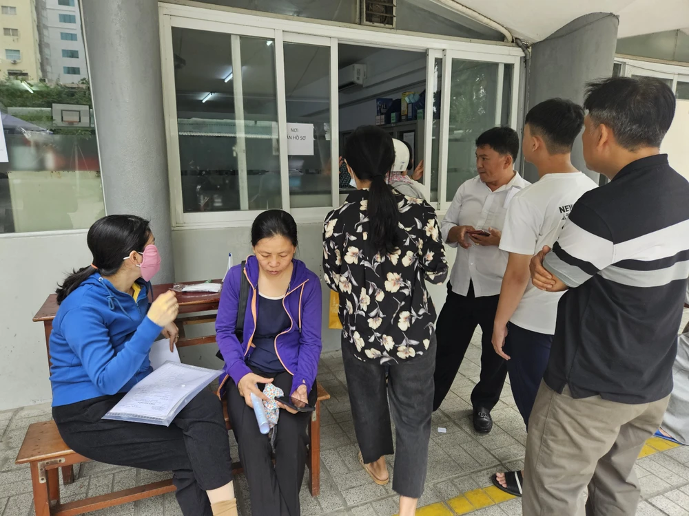 Phụ huynh chờ đợi nộp hồ sơ xét bổ sung lớp 10 tại Trường THPT Lê Thị Hồng Gấm, quận 3. Ảnh: HX tuyen-bo-sung-lop-10-1-3.jpg