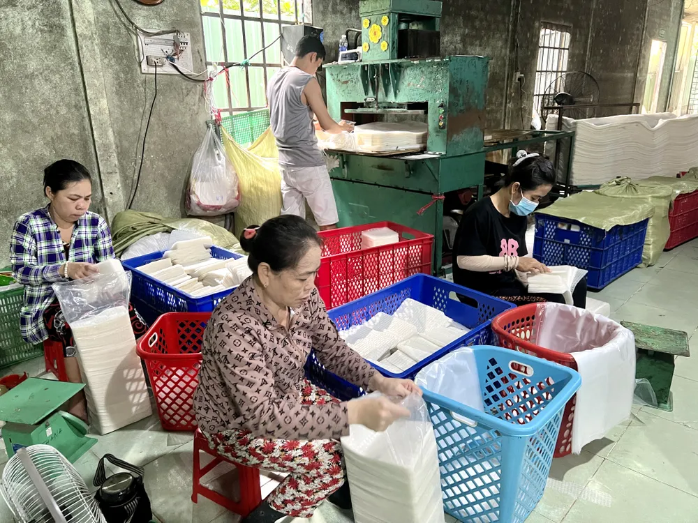Các nhân viên đang đóng gói các loại bánh tráng. Ảnh: THY NHUNG lang-nghe-banh-trang