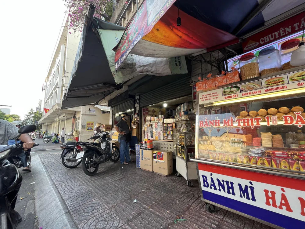 Người dân đang mua thuốc lá tại con đường chuyên bán thuốc lá quận 3. ẢNH: TÚ UYÊN