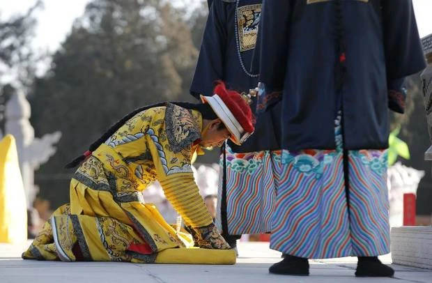 A performer, dressed as a Qing dynasty emperor, bows as he takes part in the re-enactment of the ancient Qing Dynasty ceremony in which emperors prayed for good harvest and fortune, during the opening of the temple fair for the Chinese New Year celebrations at Ditan Park, also known as the Temple of Earth, in Beijing January 30, 2014. (KIM KYUNG-HOON/REUTERS)