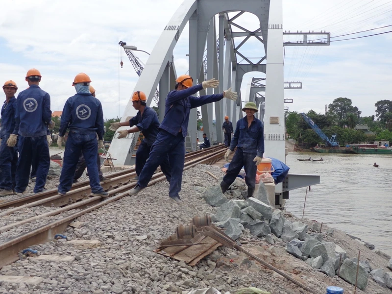 Cùng thời điểm, ở bờ Nam, công nhân đẩy nhanh thi công vách ta luy ngay sát mố cầu. Đây là hạng mục phải bảo đảm kỹ thuật để cho tàu chạy 40-60 km/giờ qua cầu.