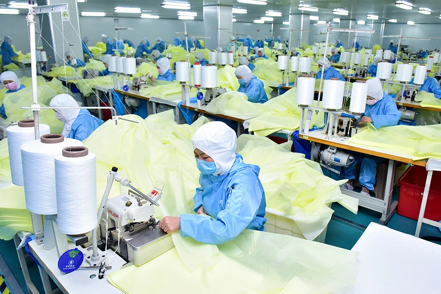 Công nhân mang khẩu trang tăng ca ở Hồ Bắc (Trung Quốc). Ảnh: CHINA DAILY