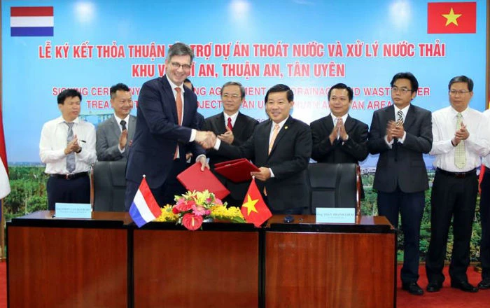 Ông Trần Thanh Liêm (phải), Chủ tịch UBND tỉnh Bình Dương và Tổng lãnh sự Cộng hòa Hà Lan tại TP.HCM hoàn thành nghi thức ký kết tài trợ. Ảnh: HL