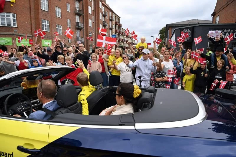 Đường phố Copenhagen, thủ đô Đan Mạch đón chào sự kiện mang tính lịch sử khi có nhà vô địch Tour de France. Người hùng Đan Mạch Jonas Vigegaard cùng vợ Trine và con gái Frida. Jonas Vingegaard là cua-rơ Đan Mạch đầu tiên vô địch Tour de France kể từ năm 1992 Bjarne Riis đến nay, tức tròn 30 năm, chiếc áo vàng danh giá của Tour de France mới quay lại Đan Mạch. Tay đua 25 tuổi này được chở diễu hành qua nhiều con phố chính ở thủ đô Copenhagen. Người hùng Jonas Vingegaard đứng trên ban công Tòa thị chính đáp lại mọi người. ...Sau đó anh về ngôi làng quê hương Glyngore, cách biển Bắc 50km, nơi có 23 ngàn người đang chào đón người con, người hùng Đan Mạch.