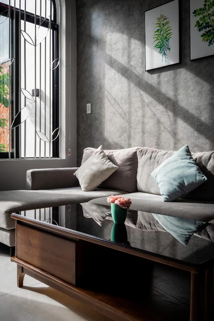 Ngôi nhà sử dụng ba loại vật liệu chính: sơn bê tông, gỗ màu tối, màu tường trắng làm nền chủ đạo.