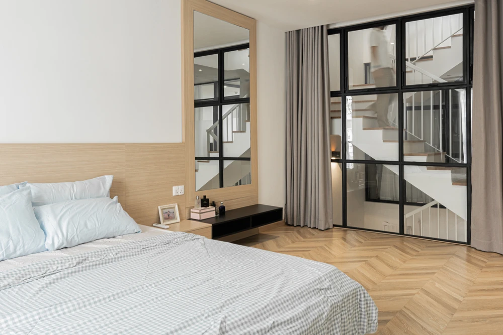 Lớp kính trong suốt phân chia không gian phòng ngủ với không gian chung và nâng cao thẩm mỹ.