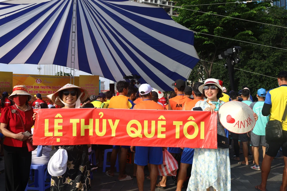 Cổ động viên nhiệt tình đến cổ vũ có các vận động viên trong hội thi đua thuyền.