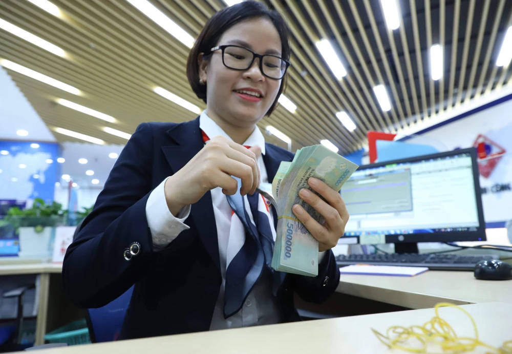 Giao dịch ngoại tệ tại một ngân hàng thương mại. Tỉ giá USD/VND đã hạ nhiệt sau nhiều tuần căng thẳng