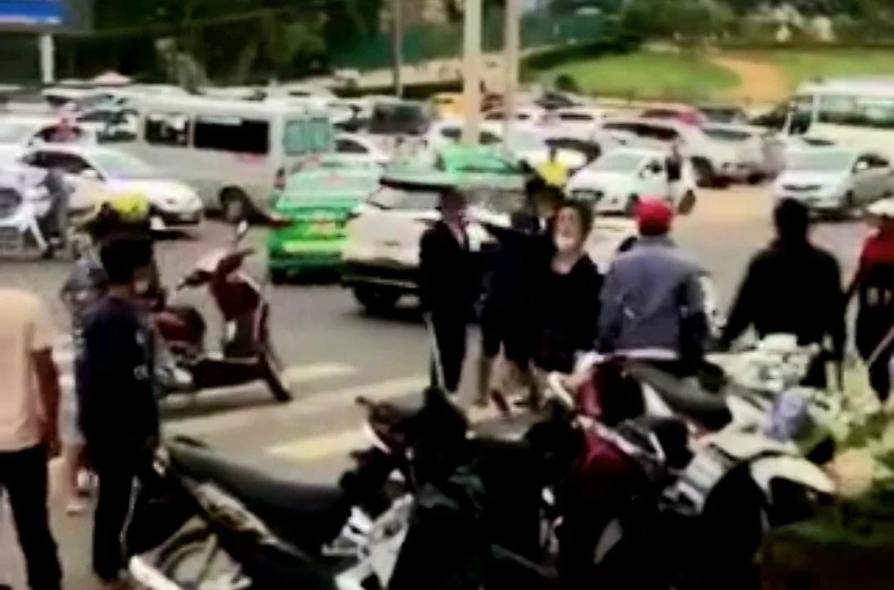 Hơn 10 người hò hét, cầm hung khí rượt đuổi nhau trước khu du lịch nổi tiếng. Ảnh cắt từ CLIP