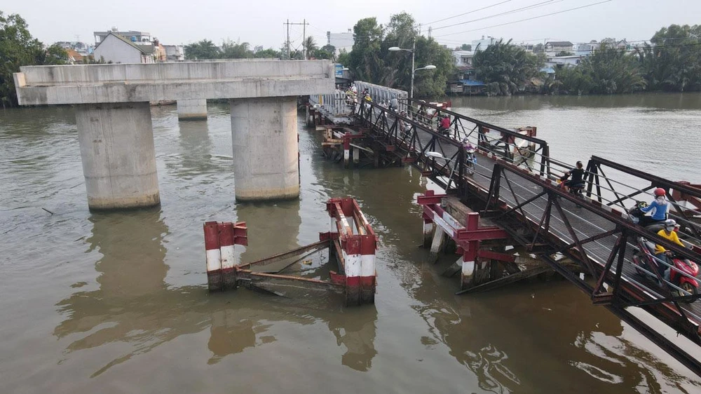 Do dự án chậm hơn 20 năm nên người dân hằng ngày phải đi lại qua cầu sắt đã xuống cấp, từng bị sập một nhịp. Ảnh: TÂM NGUYỄN