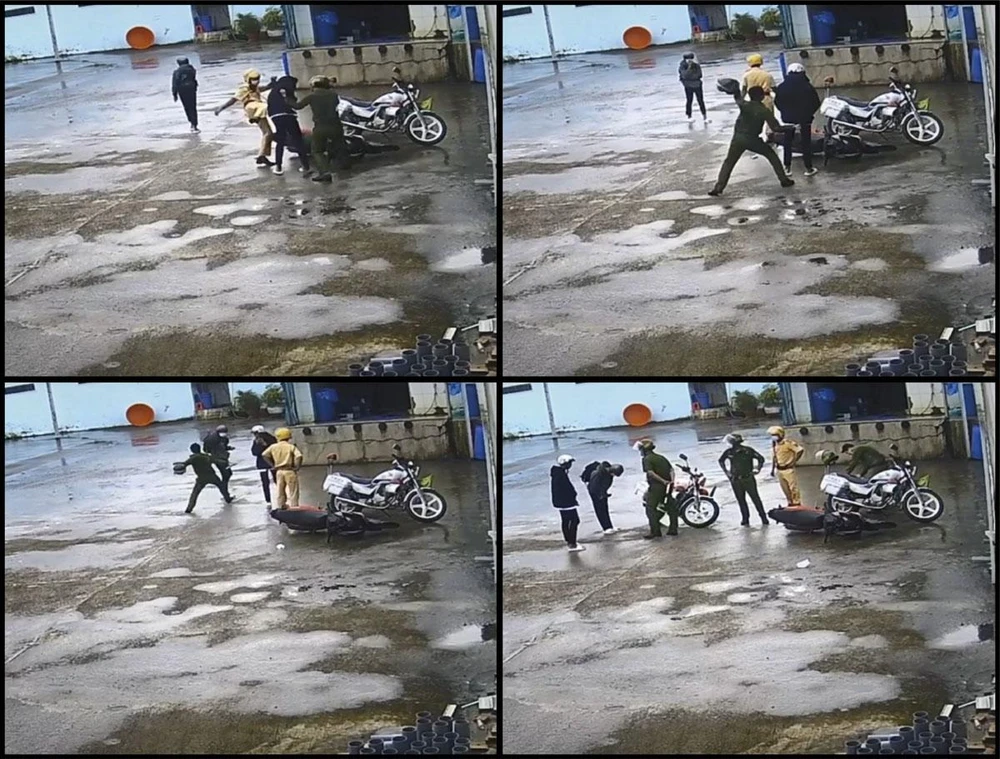 Hai công an đánh người vi phạm sau khi dừng được phương tiện. (Ảnh cắt từ clip)