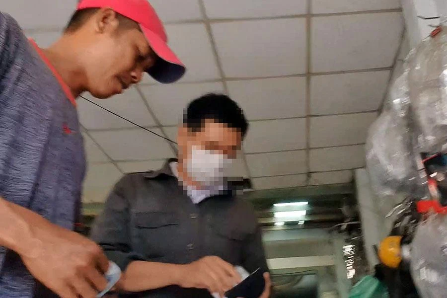 Trong tiệm Tuấn Việt 588, cò (đội nón) lấy 500.000 đồng và đưa vào trong gặp Đại úy Minh làm CCCD mà không phải bốc số, chờ đợi. Ảnh: NT - NY