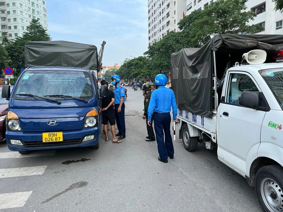Tại khu vực trước tòa nhà HH, khu đô thị Linh Đàm, một xe tải mang biển ngoại tỉnh dừng đè lên vạch báo lối đi lại cho người đi bộ đã bị thanh tra giao thông đến kiểm tra, lập biên bản vi phạm.