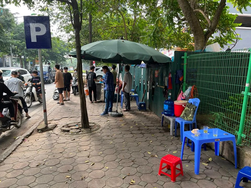 Chủ các quán nước giải khát tại khu vực vỉa hè hồ Linh Đàm (phường Hoàng Liệt) dọn dẹp khi biết lực lượng chức năng xử lý tình trạng lấn chiếm lòng đường, vỉa hè.