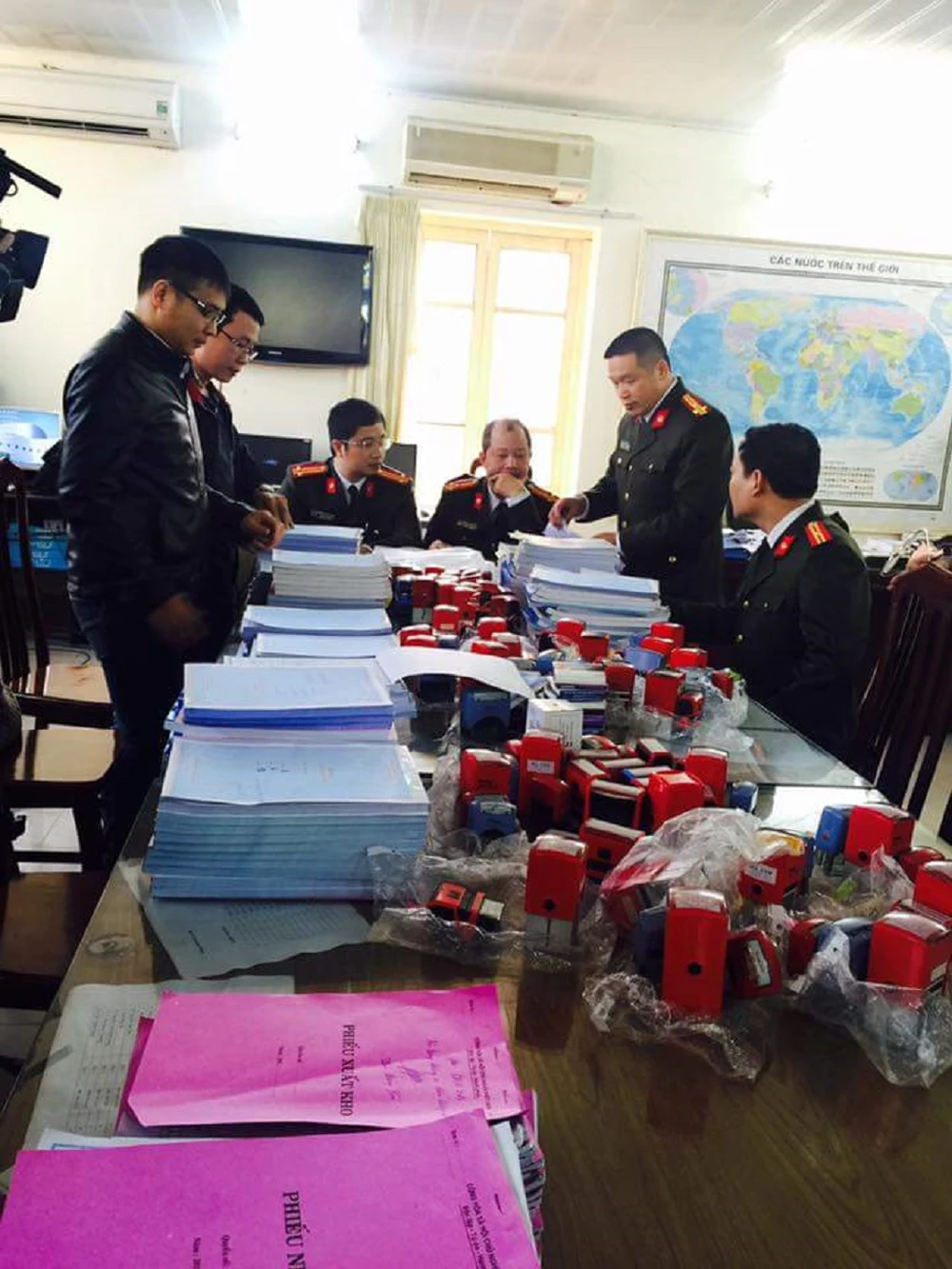 Hóa đơn giả mạo và con dấu bị thu giữ tại cơ quan điều tra.