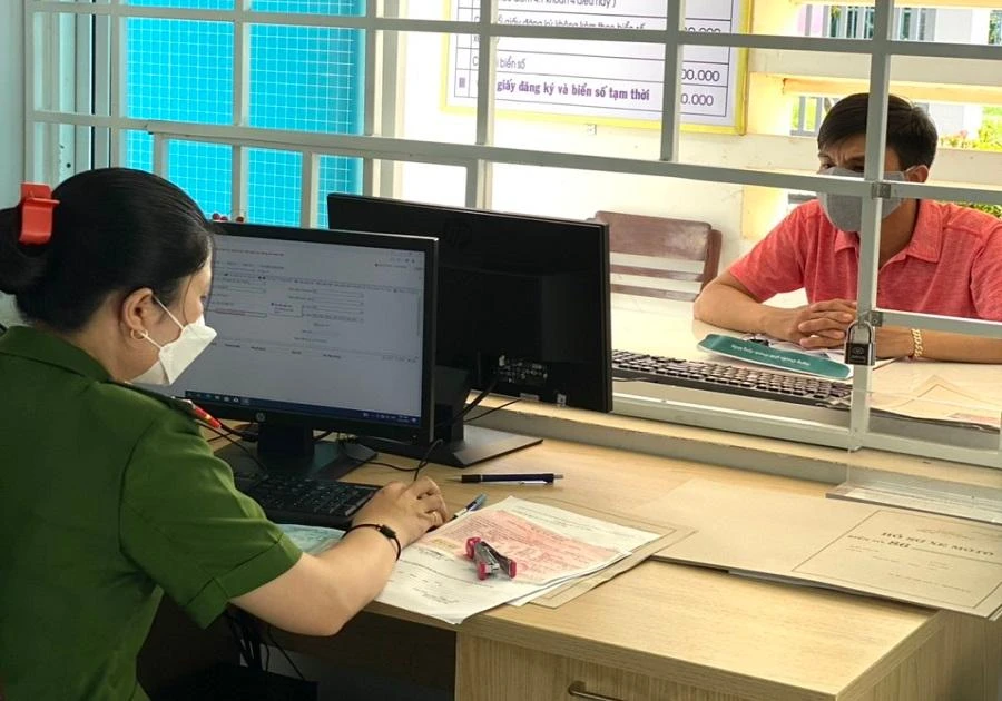 Lực lượng công an cấp xã cấp đăng ký và biển số xe máy cho người dân. Ảnh: NHẬT NHẬT