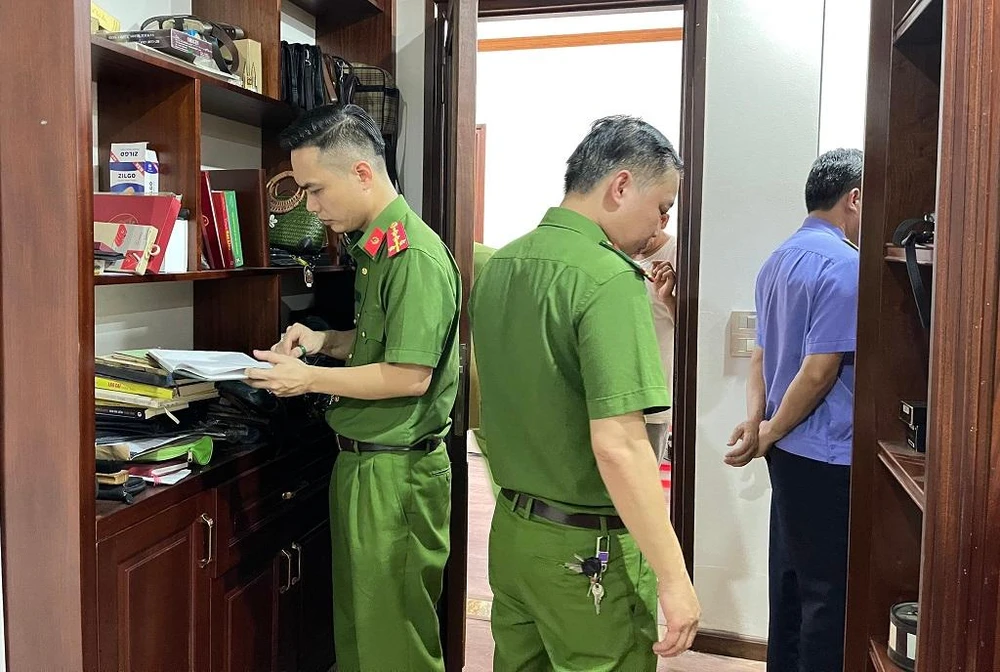 Công an thực hiện lệnh khám xét trong quá trình điều tra vụ án. Ảnh: CA