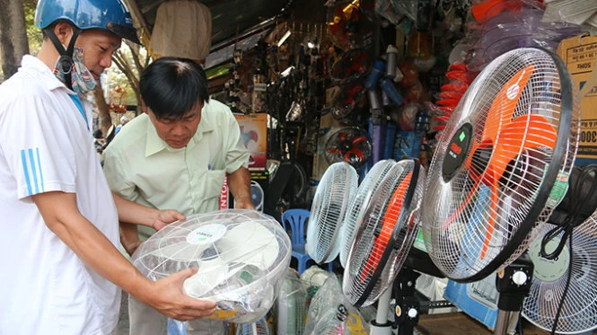 Người dân mua quạt điện chống nóng tại một cửa hàng điện máy trên đường Yersin (Q.1, TP.HCM) - Ảnh: Tiến Long