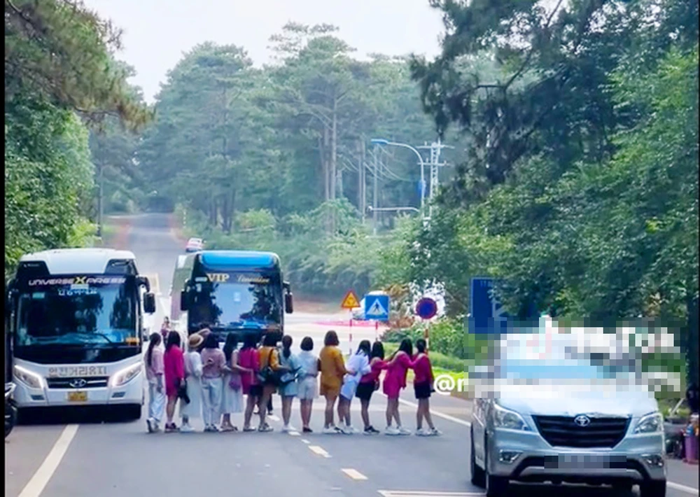 Nhóm nữ du khách dàn hàng ngan chụo ảnh trên quốc lộ 24 đoạn qua thị trấn Măng Đen