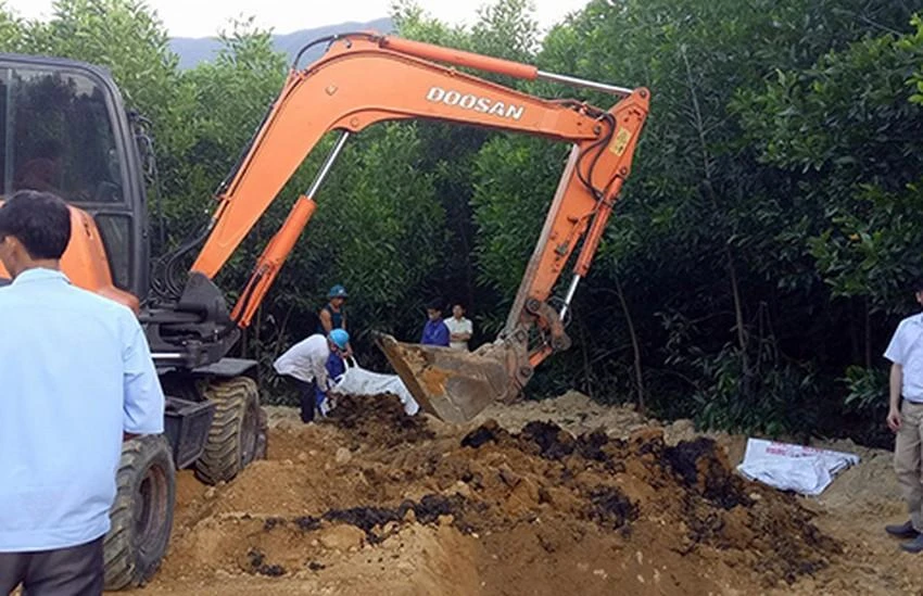 Lực lượng chức năng đang đào, thu gom bùn thải của Formosa. Ảnh: VIẾT LONG