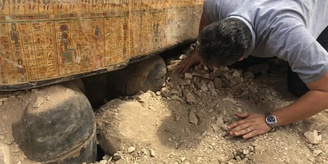 Egyptian Minister of Antiquities Khaled el-Anany looking at recently discovered coffins in Luxor.
