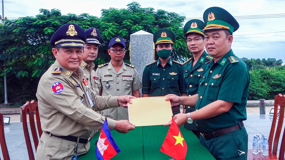 Đồn Biên phòng Cửa khẩu quốc tế Hà Tiên và lực lượng chức năng Campuchia trao biên bản bàn giao và tiếp nhận 67 công dân Việt Nam về nước. Ảnh: Cổng thông tin Tỉnh ủy Kiên Giang