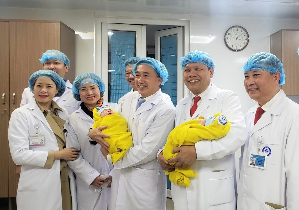 Thứ trưởng Bộ Y tế Trần Văn Thuấn và PGS.TS Trần Danh Cường (Giám đốc BV Phụ sản Trung ương) cùng các y, bác sĩ trong niềm vui đón những em nhỏ đầu tiên chào đời trong năm mới. Ảnh: T.AN