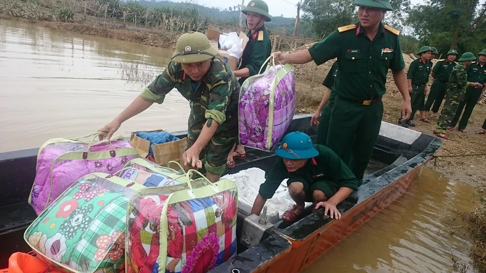 Lực lượng quân đội vào phát quà,, cứu trợ và giúp bà con nhân dân vùng lũ huyện Hương Khê (Hà Tĩnh) dọn vệ sinh, khôi phục sản xuất. Ảnh: Đ.Lam