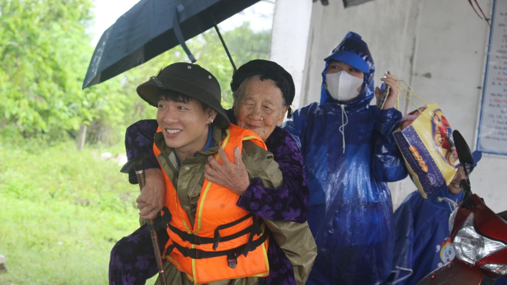 Cụ bà Hồ Thị Ngoan (95 tuổi, trú xã Nghi Xuân, tỉnh Hà Tĩnh) được thanh niên cõng, đưa đến Trường Mầm non Xuân Giang (Hà Tĩnh) để tránh, trú bão.