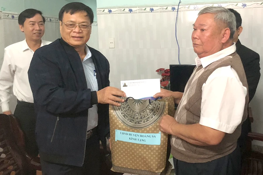 Đoàn trao quà cho ông Trần Văn Sơn. Ảnh: NGÔ QUANG